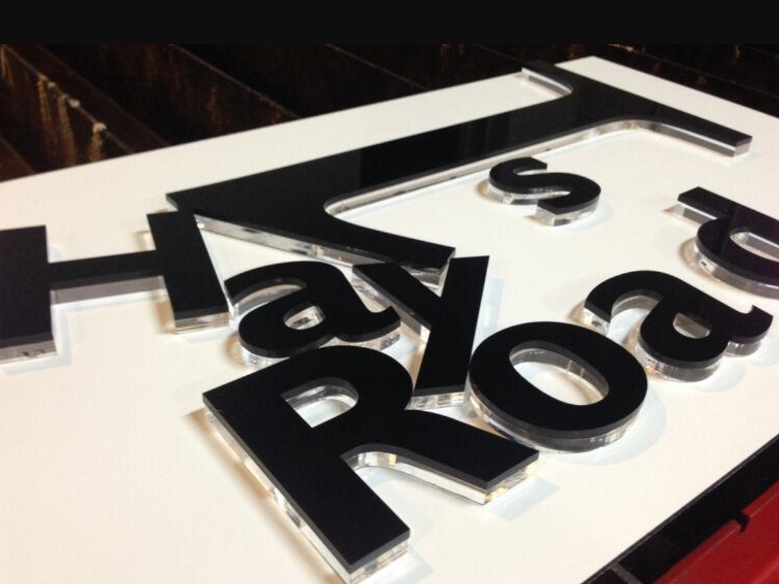 Clear acrylic cut-out signage with vinyl sticker graphics application