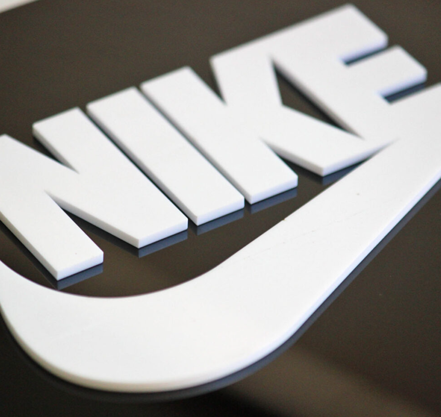 Nike swoosh acrylic cut-out signage for sports retail store branding