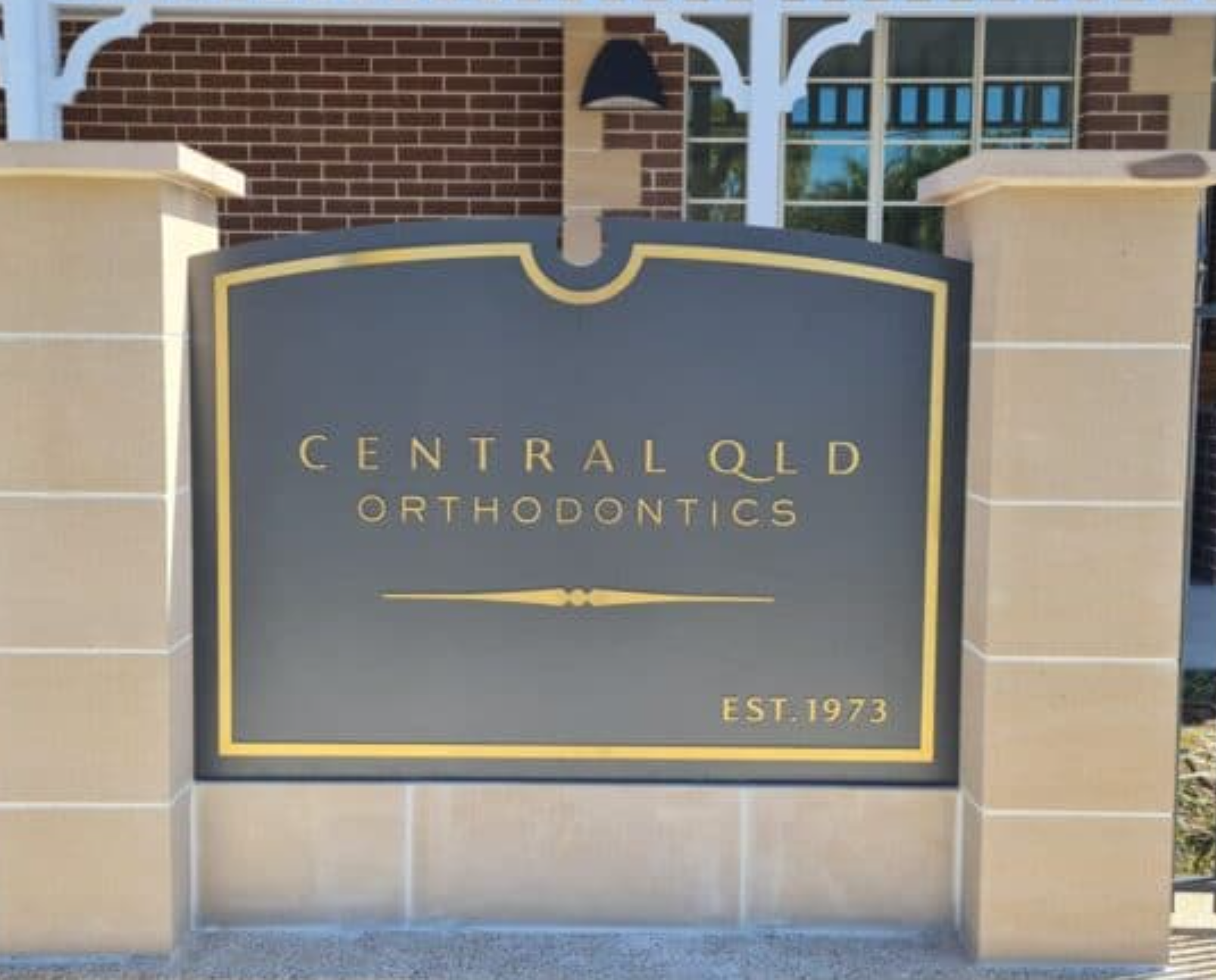 Black on gold die-cut stencil lettering for premium brand signage