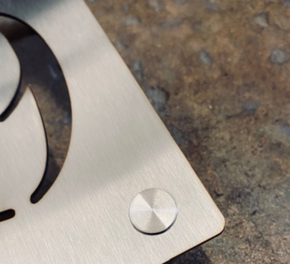 Brushed stainless steel die-cut stencil with modern industrial finish