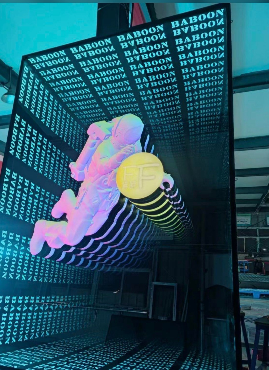 Infinity mirror signage with astronaut design creating optical illusion effect