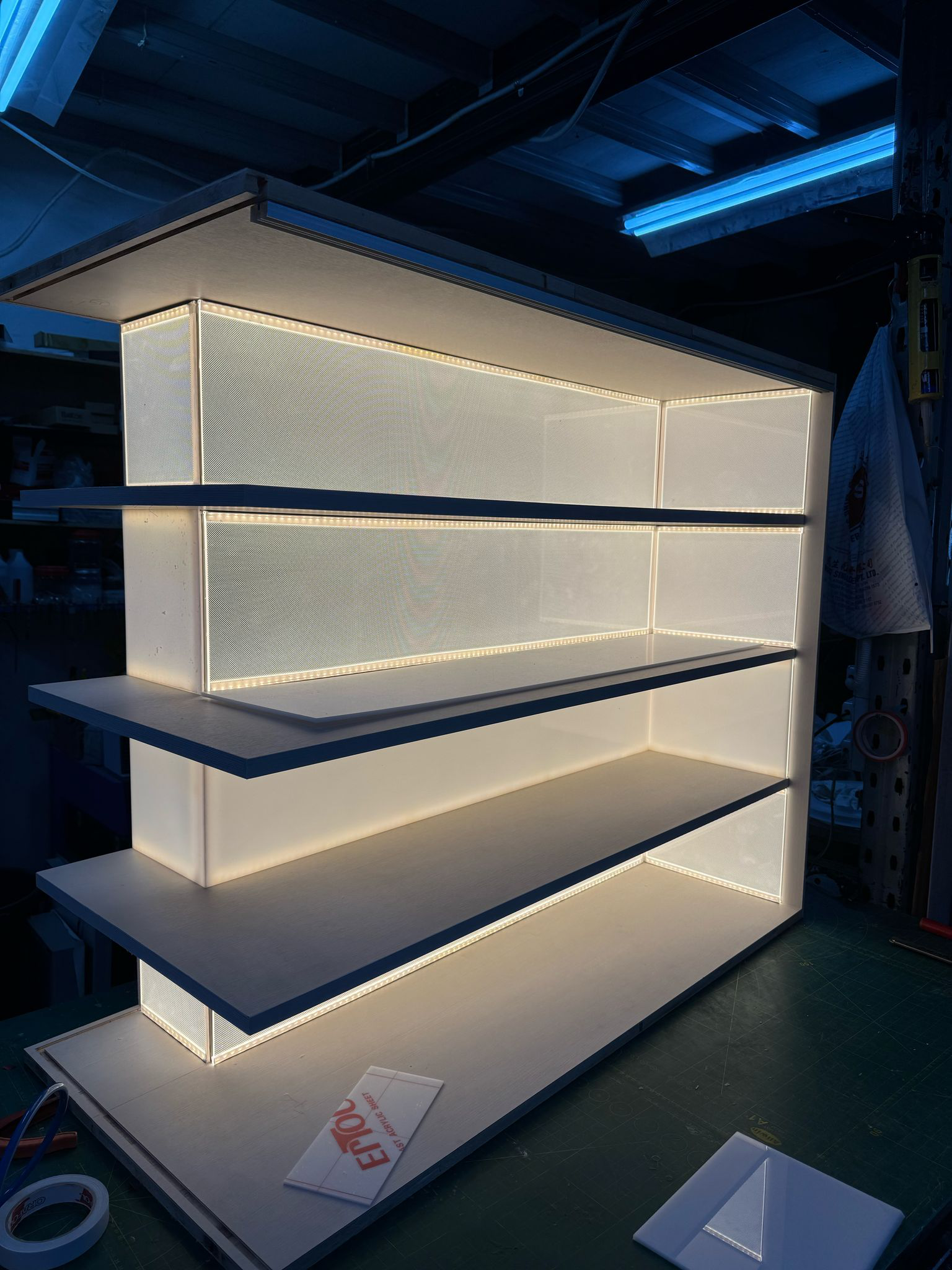 Lumisheet LED light guide panels illuminating modern bookshelf display in retail environment